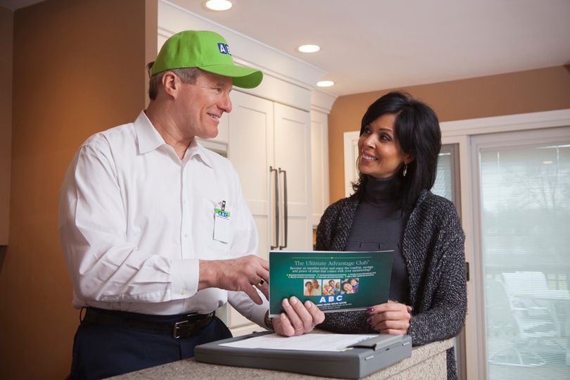 ABC technician speaking to a homeowner about maintenance services