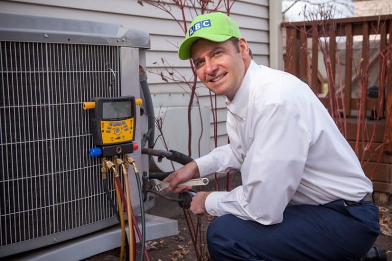 ABC HVAC technician conducting maintenance on an outdoor HVAC unit